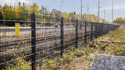 Junan raiteet ja asema-alue on suojattua aitaamalla mustalla elementtiaidalla.